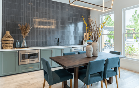 a dining room with a wooden table and blue chairs