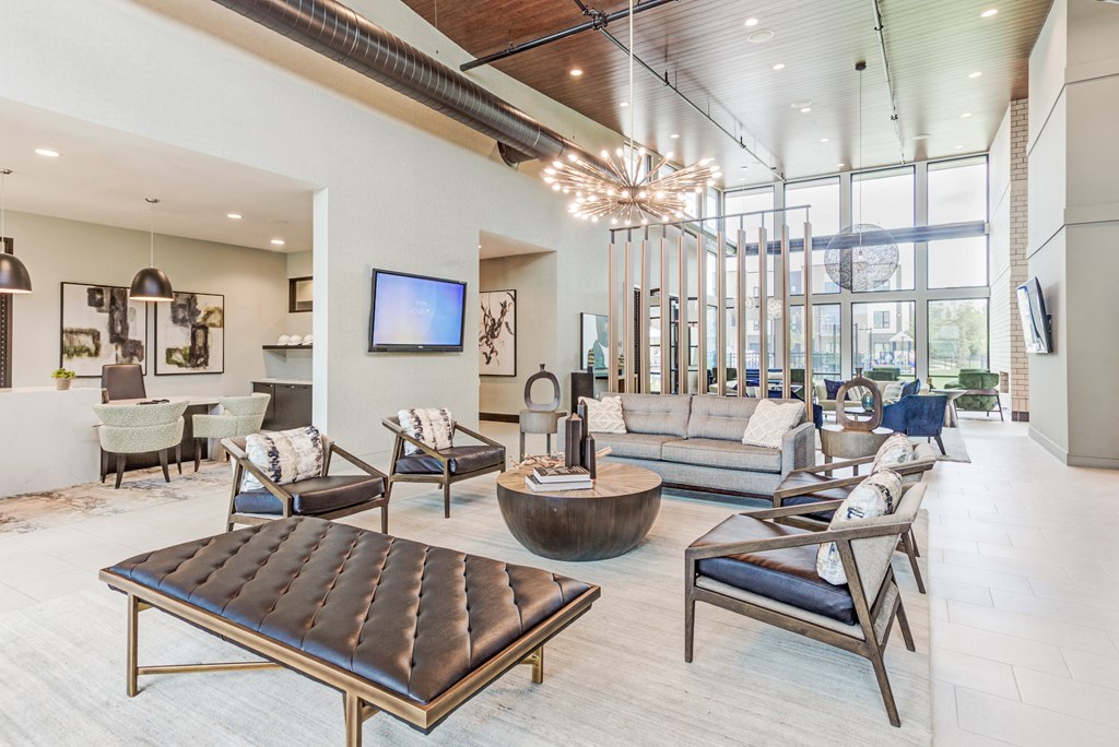 a living room with couches and chairs and a tv
