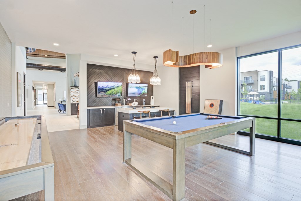 a game room with a pool table and a bar