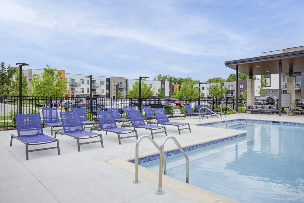 our apartments have a resort style pool with blue lounge chairs