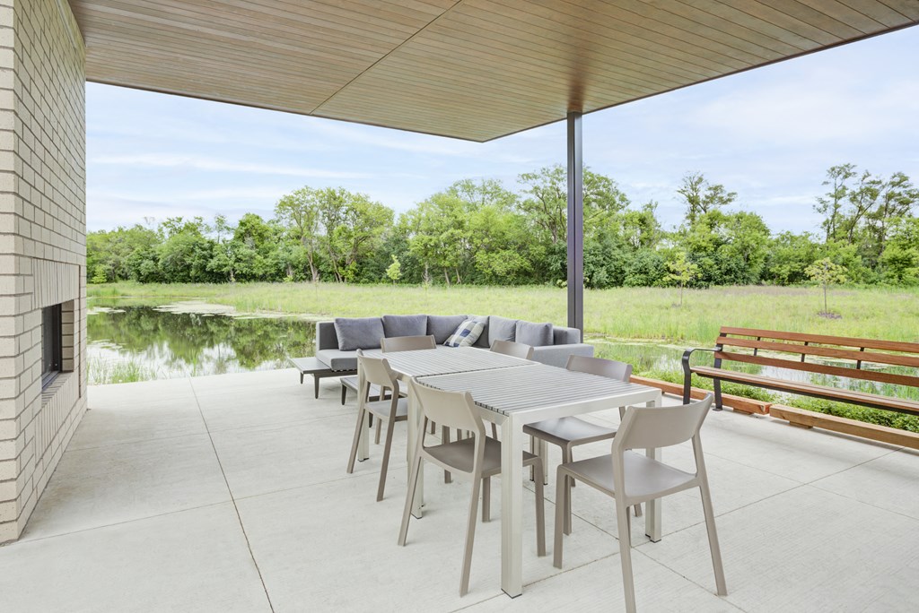 a covered patio with a table and chairs