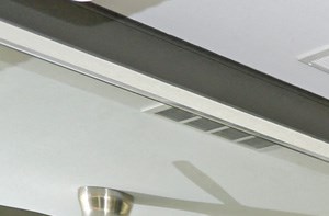 a gym with a lot of exercise equipment and a ceiling fan