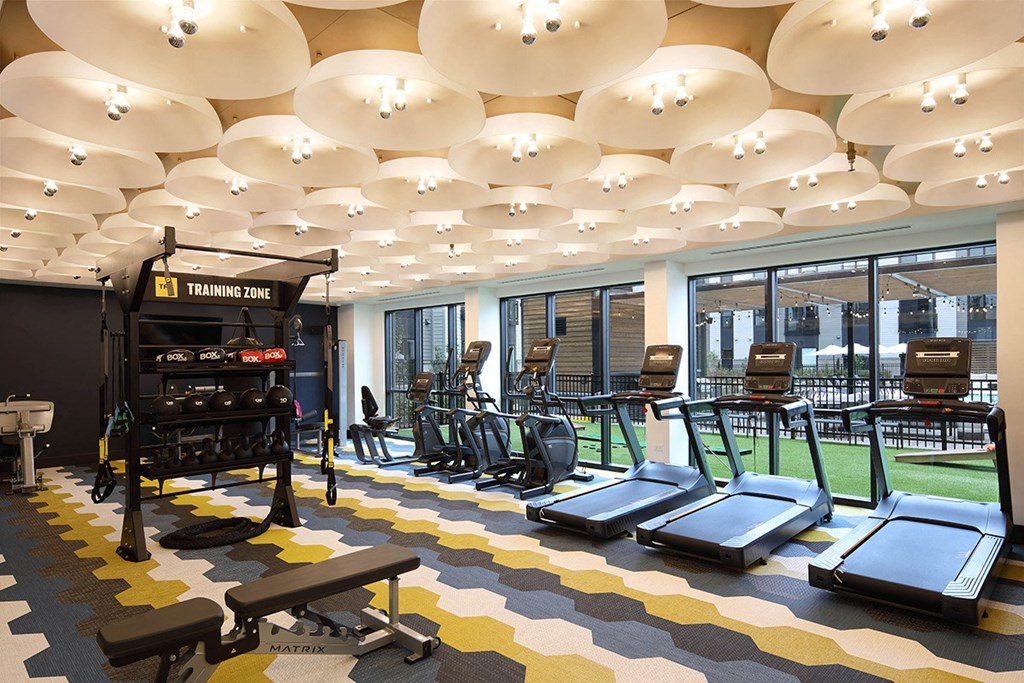 a gym with a variety of exercise equipment in the lobby of a building