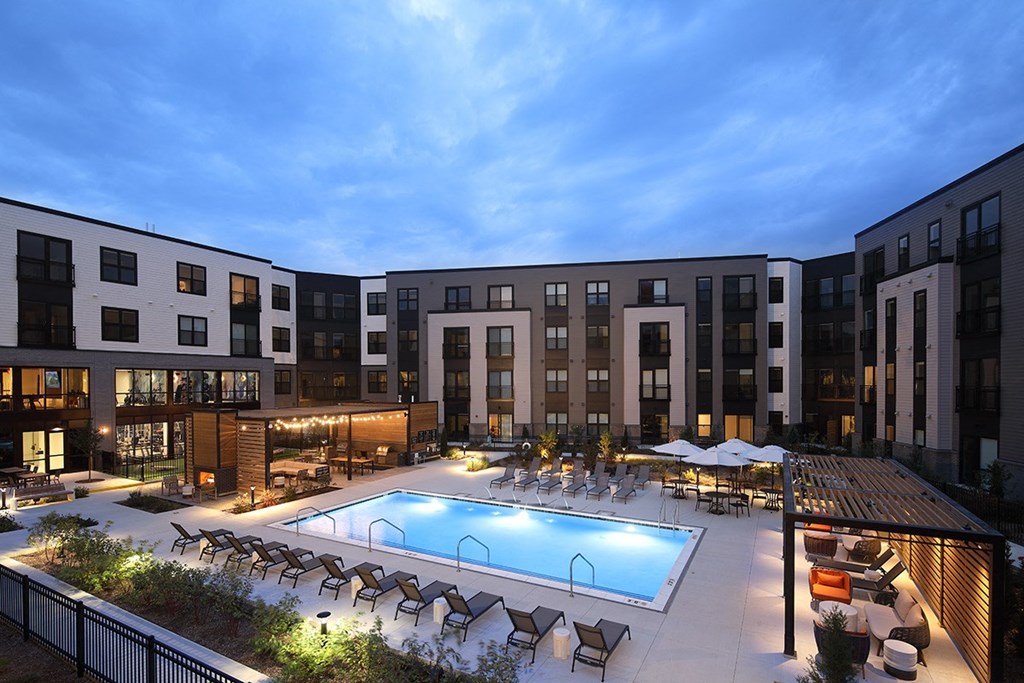 a rendering of a pool in front of an apartment building