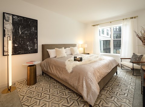 a bedroom with a bed and a painting on the wall