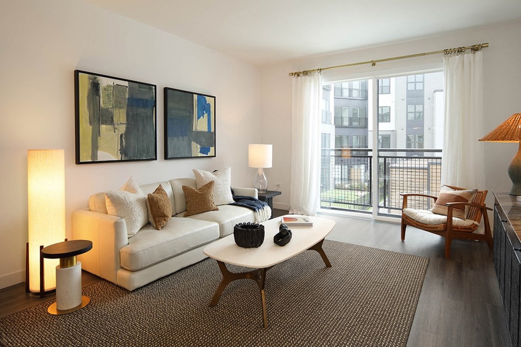 a living room with a couch and a table and a window