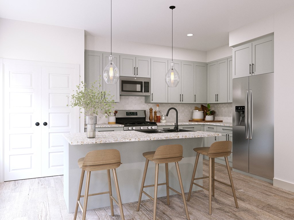 a kitchen with stainless steel appliances and a counter with three stools