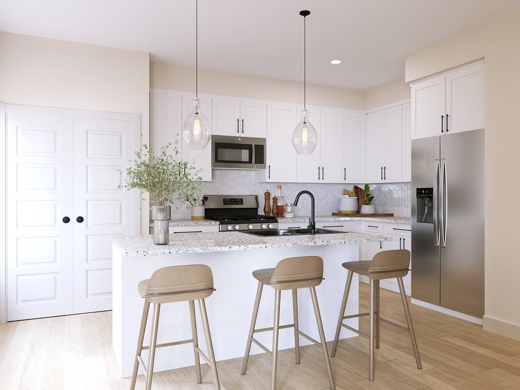 a modern kitchen with white cabinets and a counter with three stools