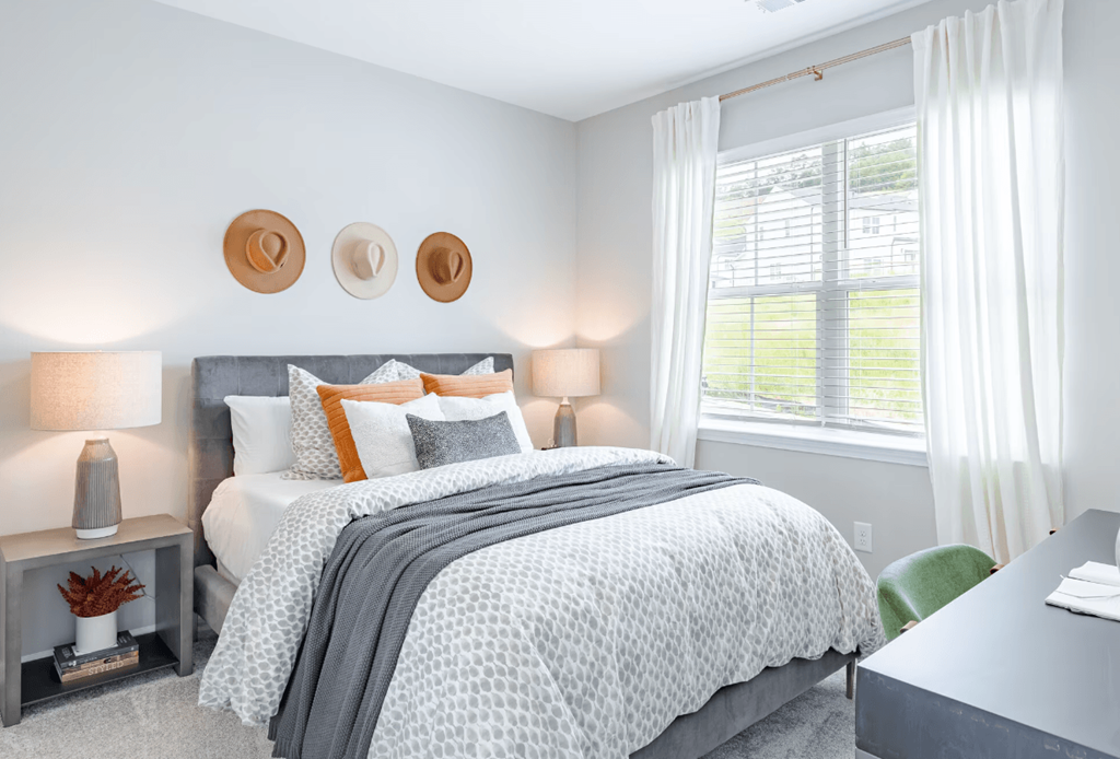 a bedroom with a bed and two windows