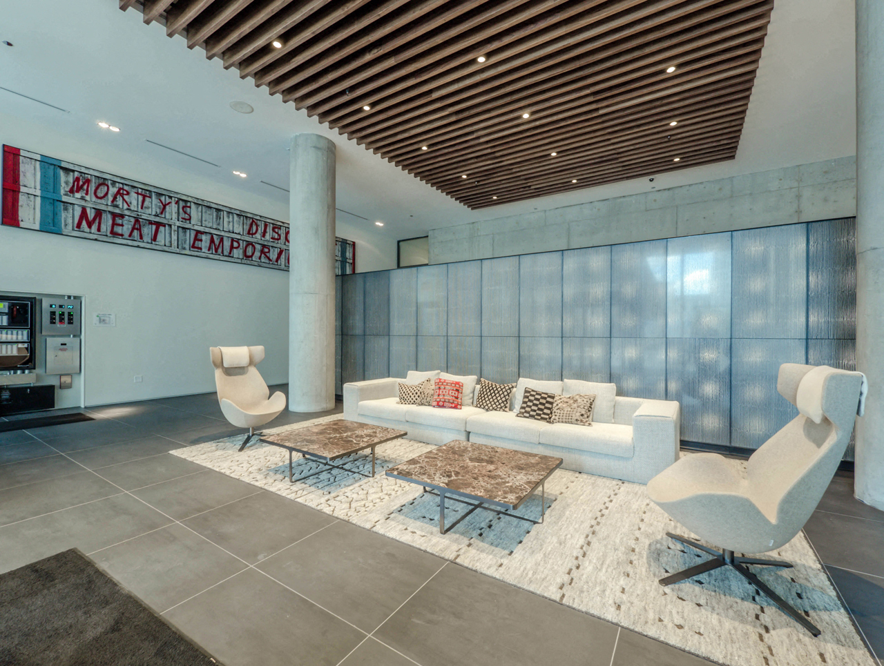 Indoor resident lounge with couches, chairs and tables The Parker Fulton Market in Chicago, IL