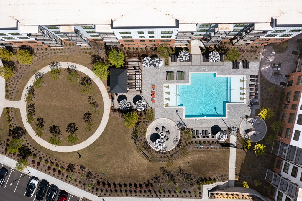 an aerial view of the courtyard of a building with a swimming pool