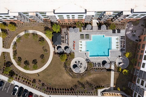 an aerial view of the courtyard of a building with a swimming pool