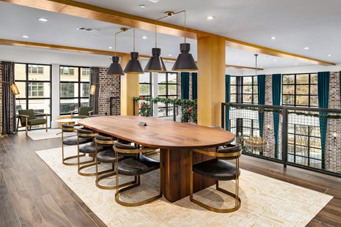 a large dining room with a wooden table and chairs