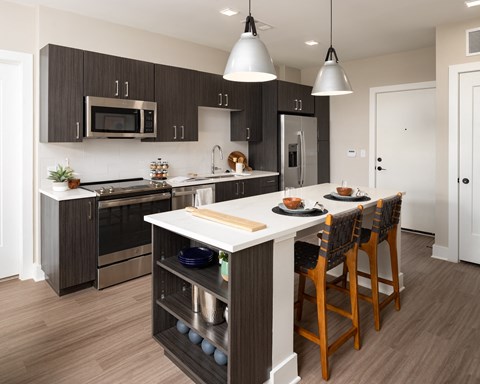a kitchen with a large island with a white counter top