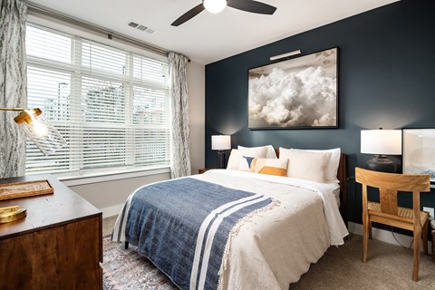 a bedroom with a bed and a large window