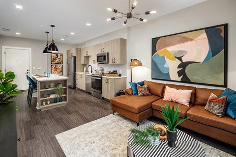 a living room and kitchen with a couch and a coffee table