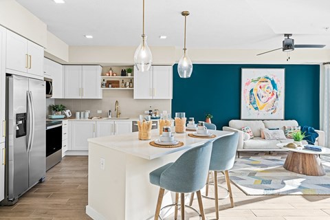 an open kitchen and living room with a table and chairs
