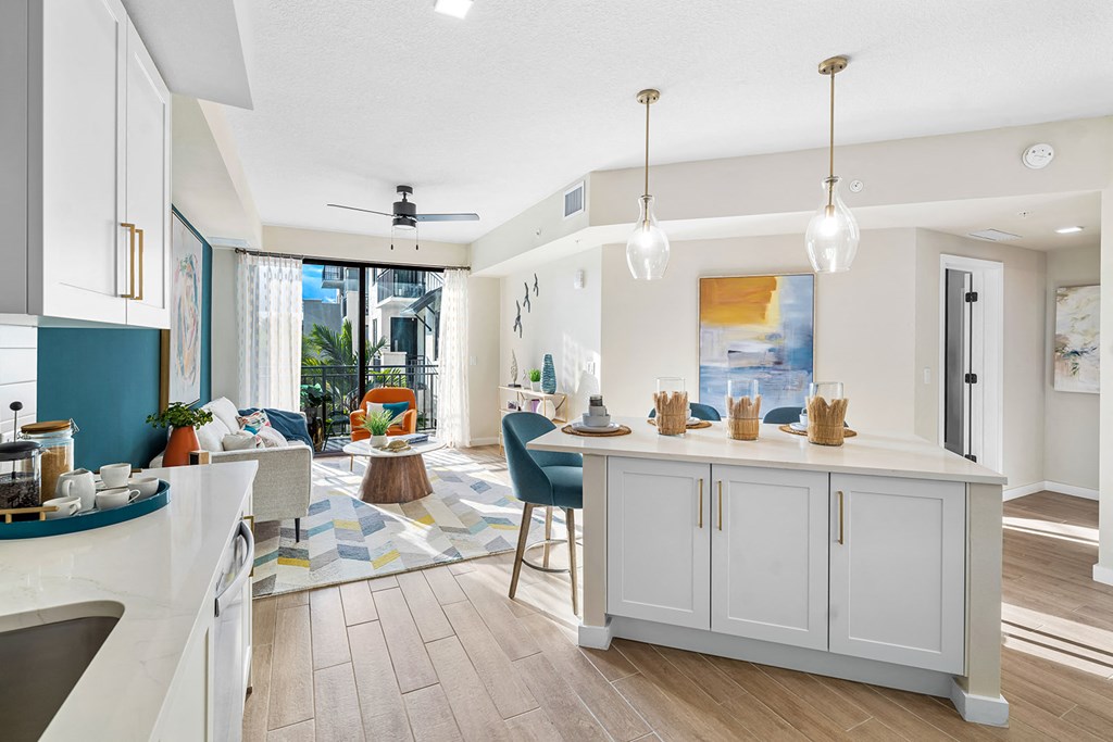 a kitchen with an island and a living room