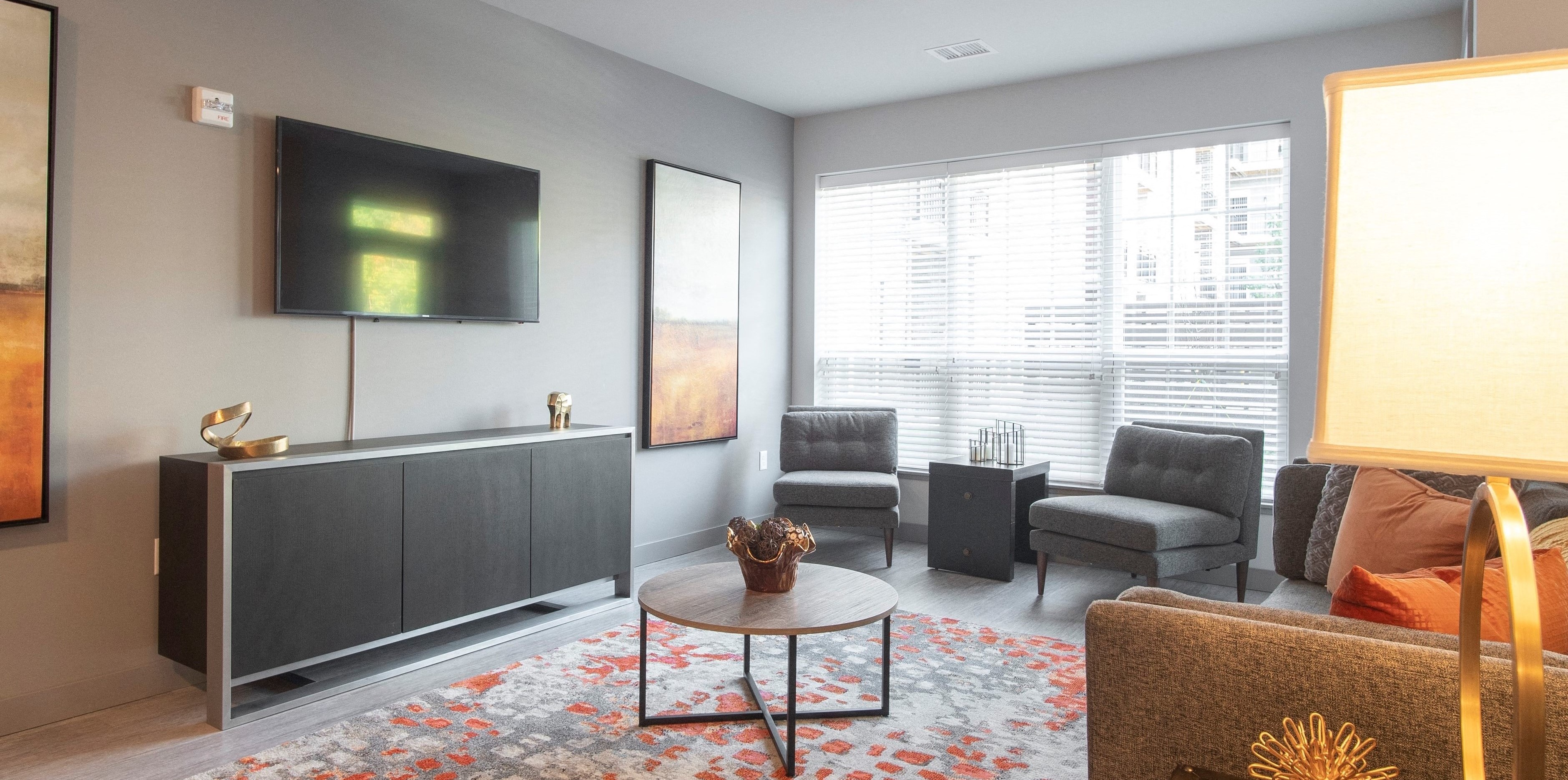 Living room with couches, accent chair, and TV.