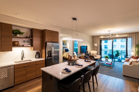 A modern kitchen with a dining table and chairs.