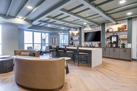 A modern open plan living and kitchen area with a curved sofa.