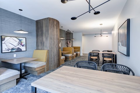 A modern dining area with a long table and chairs.