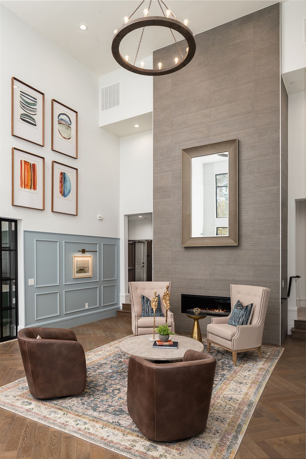 A living room with a fireplace, a chair, a sofa, a table, and a rug.