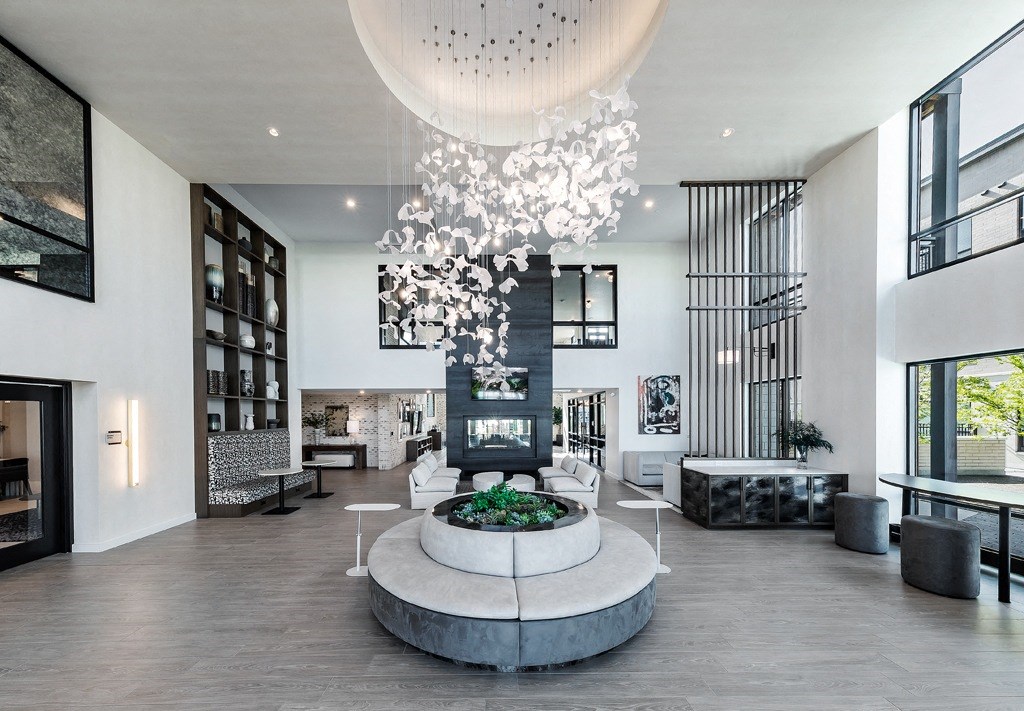 a circular lobby area with a fireplace and a chandelier