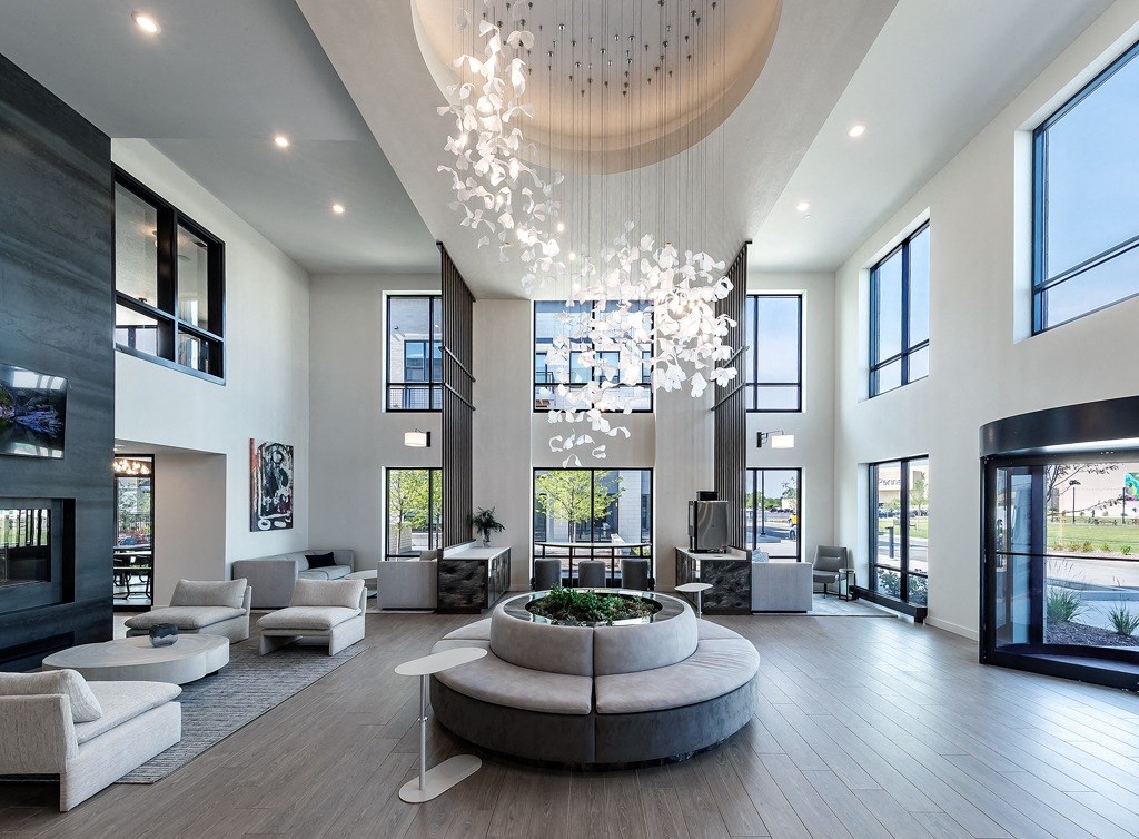 a large living room with couches and a large chandelier
