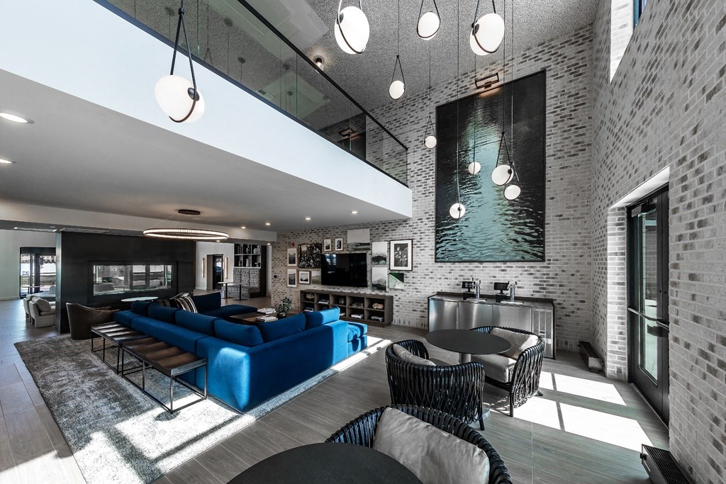 a living room with a blue couch and a table and chairs