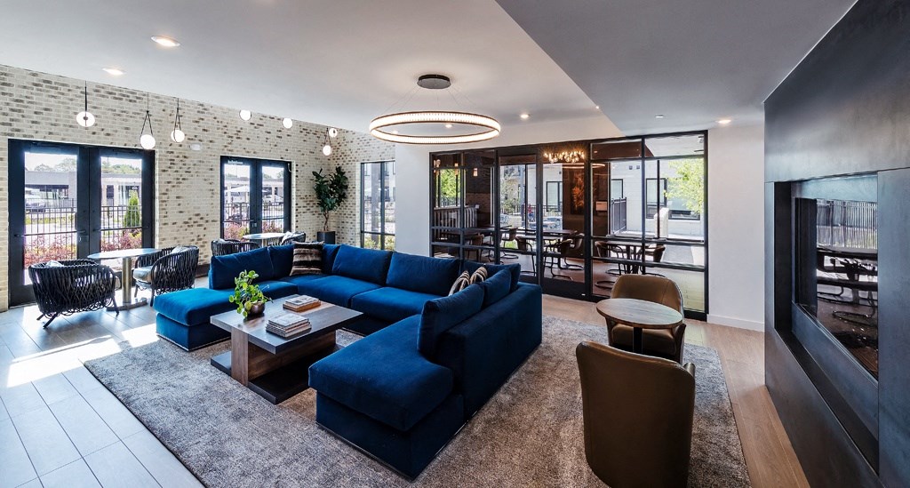 a living room with a blue couch and a table