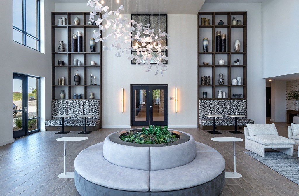 a living room with a round lobby area and a chandelier