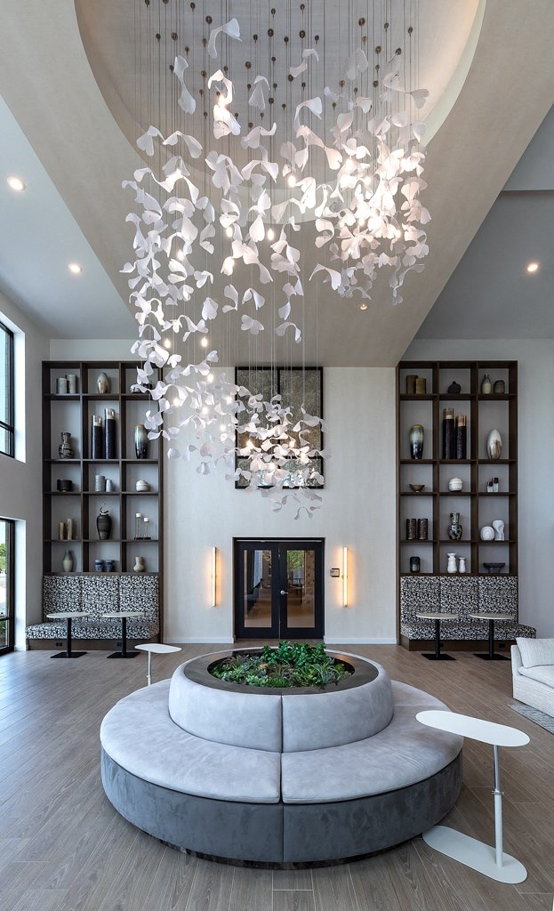 a living room with a fireplace and a large chandelier