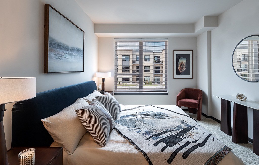 a bedroom with a bed with pillows and a blanket