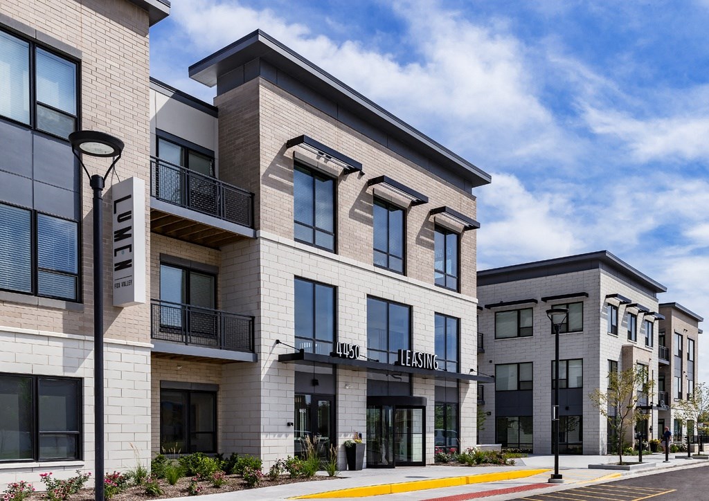 a rendering of a new apartment building on a city street