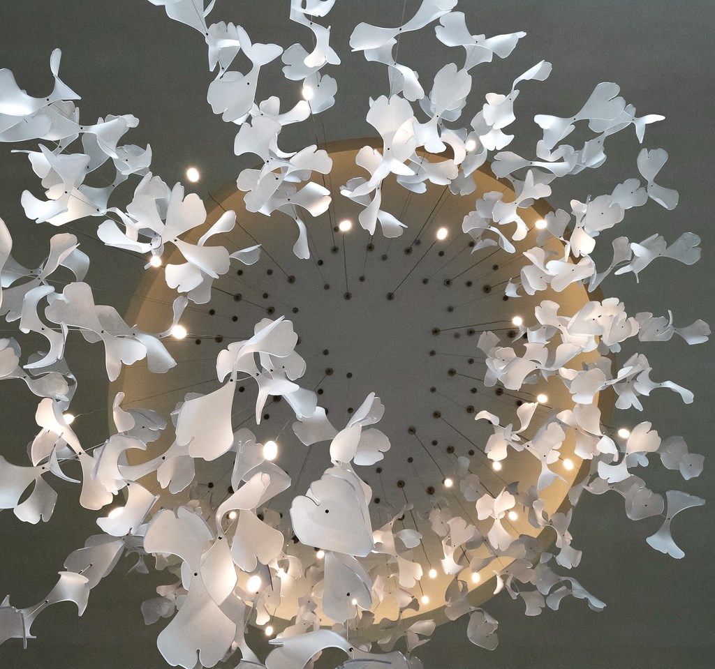 a chandelier made out of paper butterflies on a ceiling