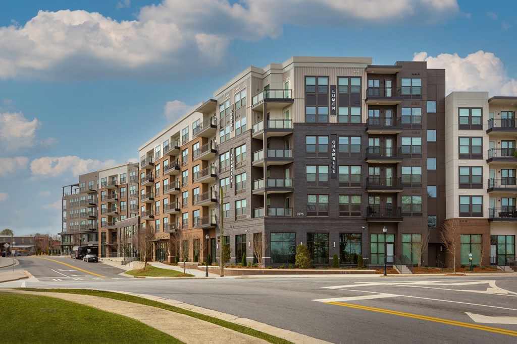 a large apartment building on the corner of a street