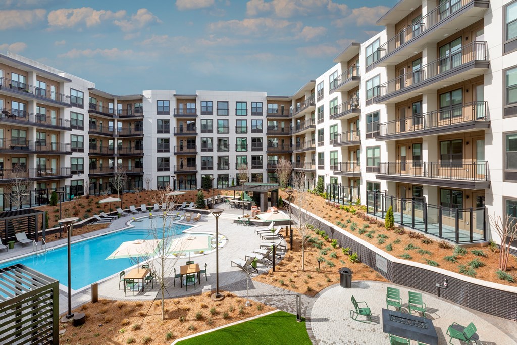 an apartment building with a swimming pool and a courtyard