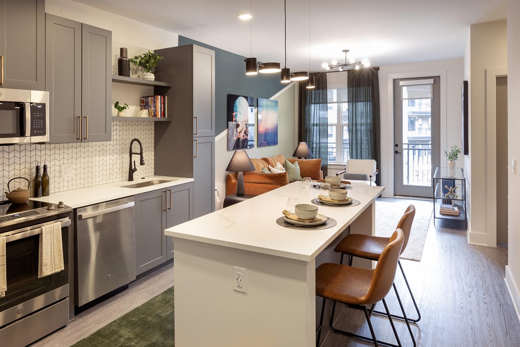 an open kitchen and living room with a table and chairs