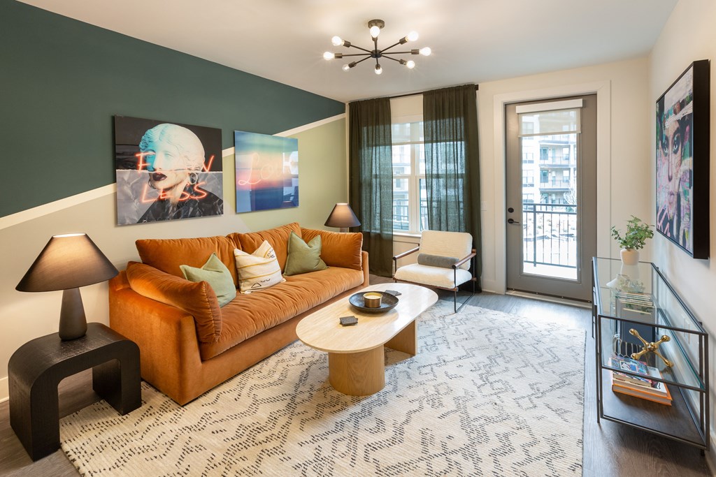 a living room with a orange couch and a coffee table