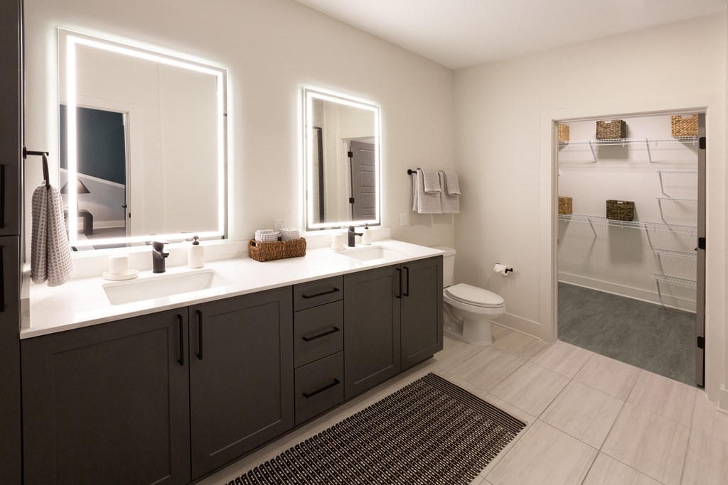 a bathroom with two sinks and a shower and a toilet