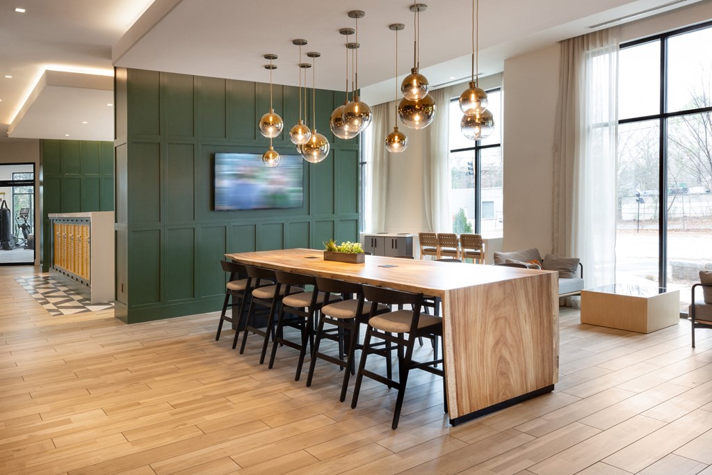 a large dining room with a wooden table and chairs