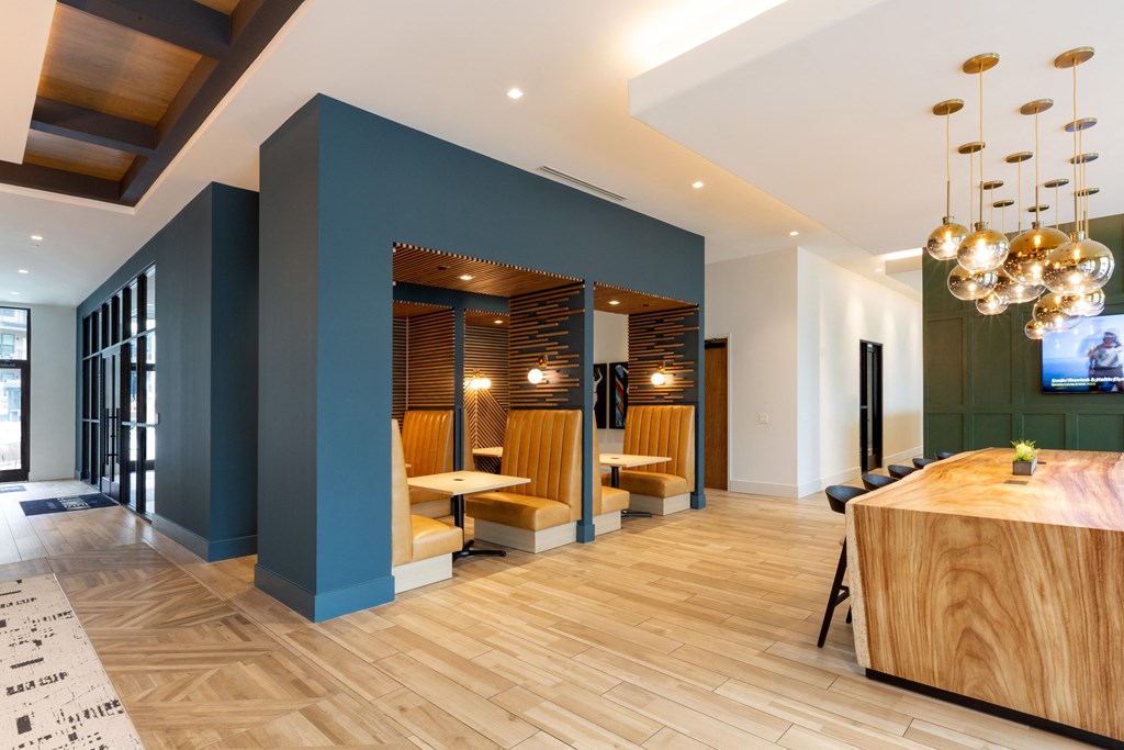 a large lobby with a table and chairs and a reception desk