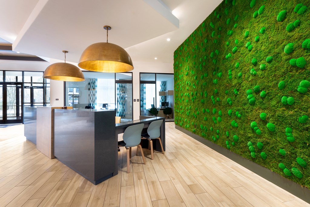 a living wall in an office with a table and chairs