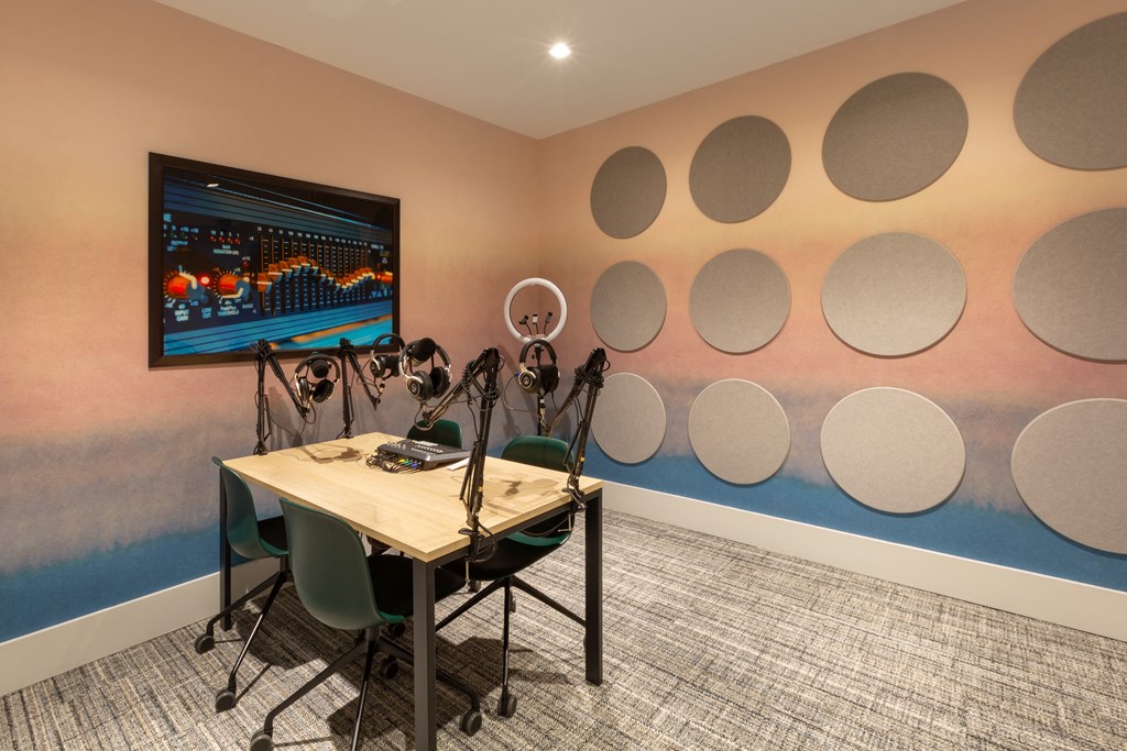 a conference room with a table and chairs and a wall with circles on the wall
