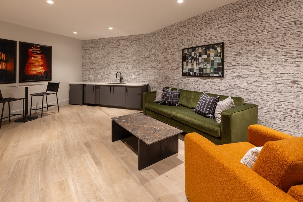 a living room with a green couch and a table