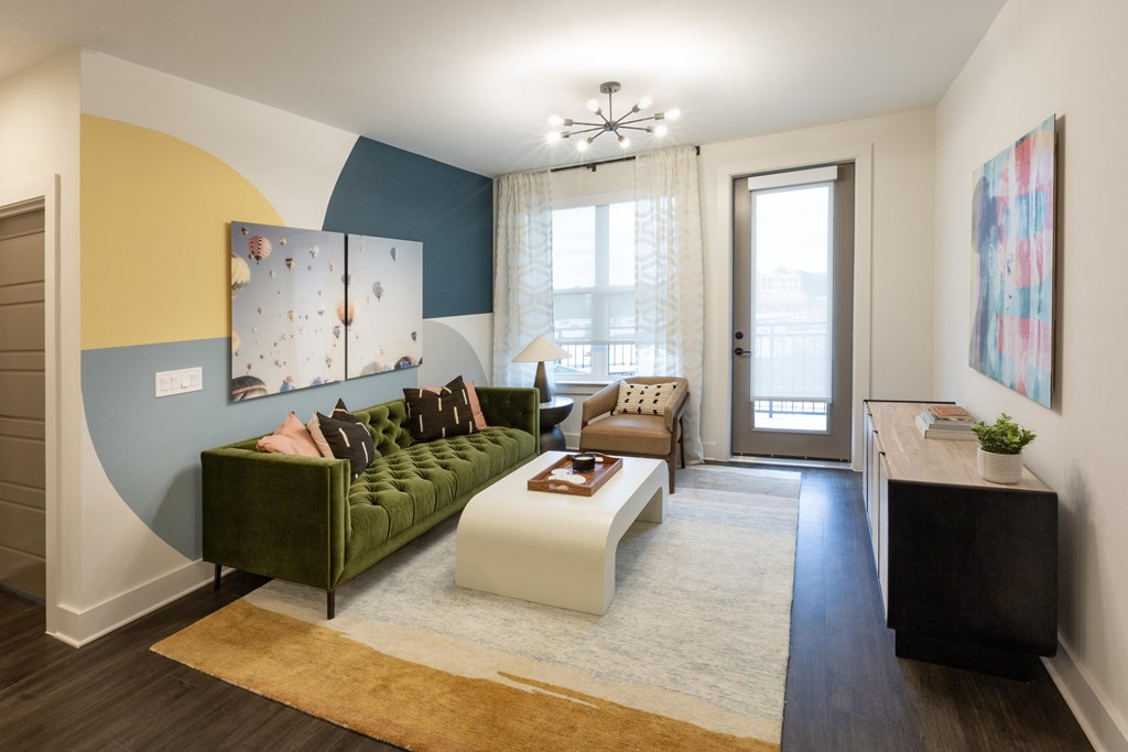 a living room with a green couch