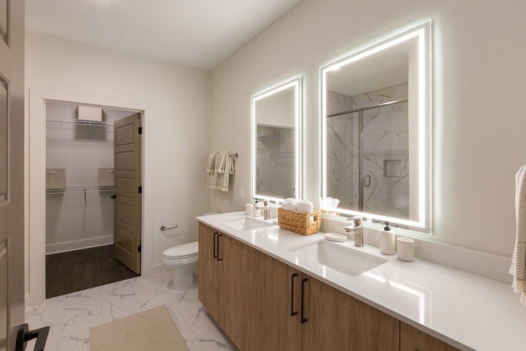 a bathroom with a sink and two mirrors