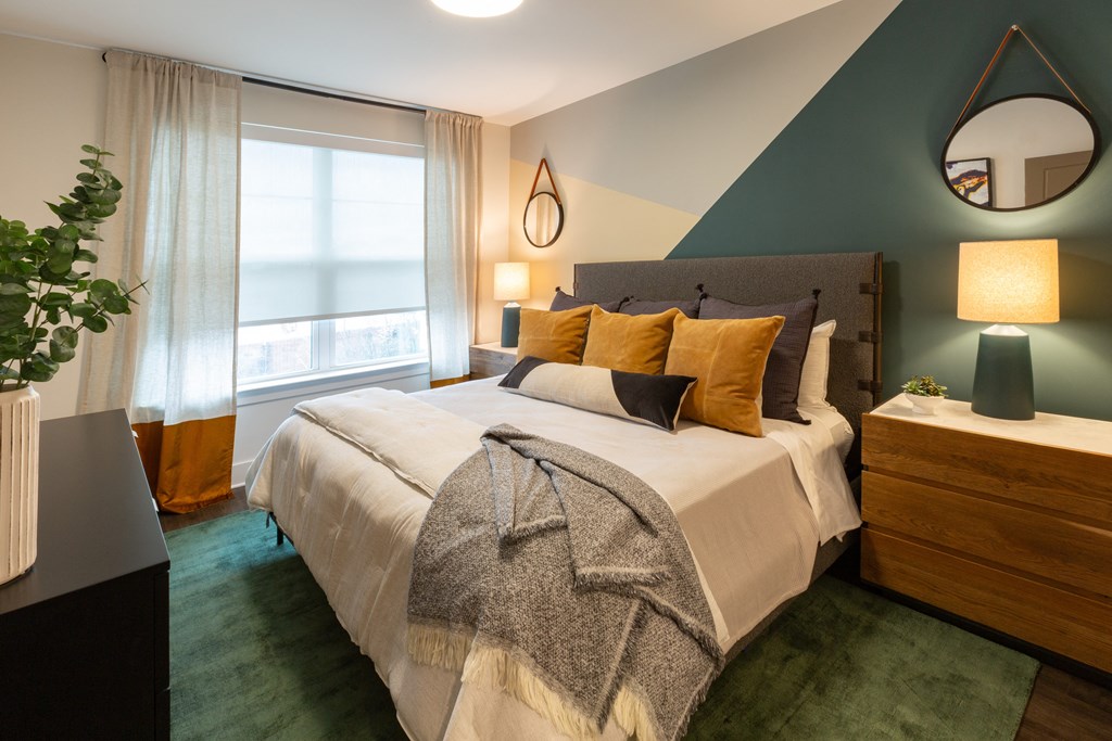 a bedroom with a large bed and a window