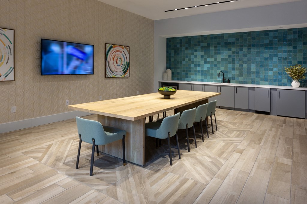 a dining room with a wooden table and chairs